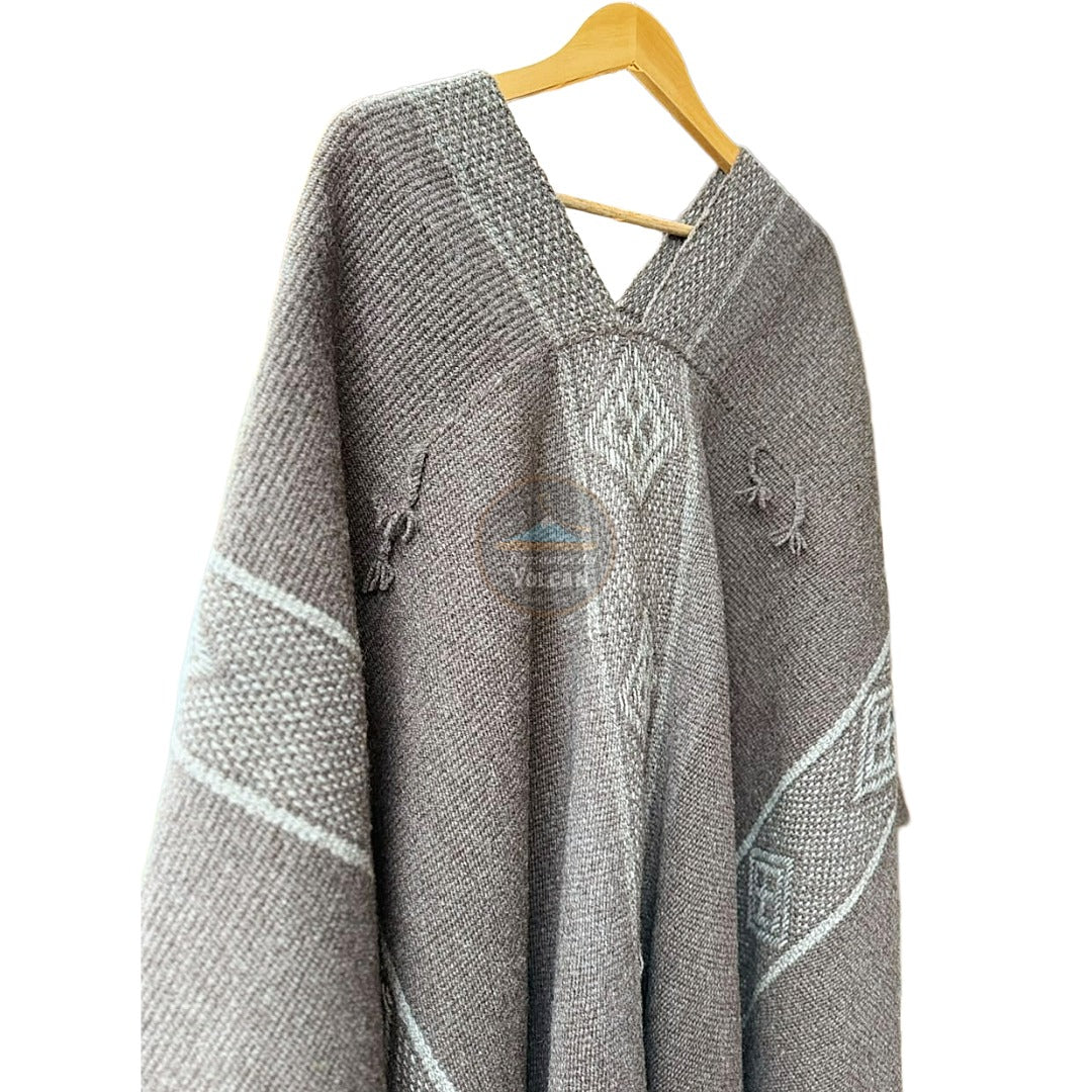Manta tejida a telar mapuche hecha en lana de oveja color gris con diseños color blanco